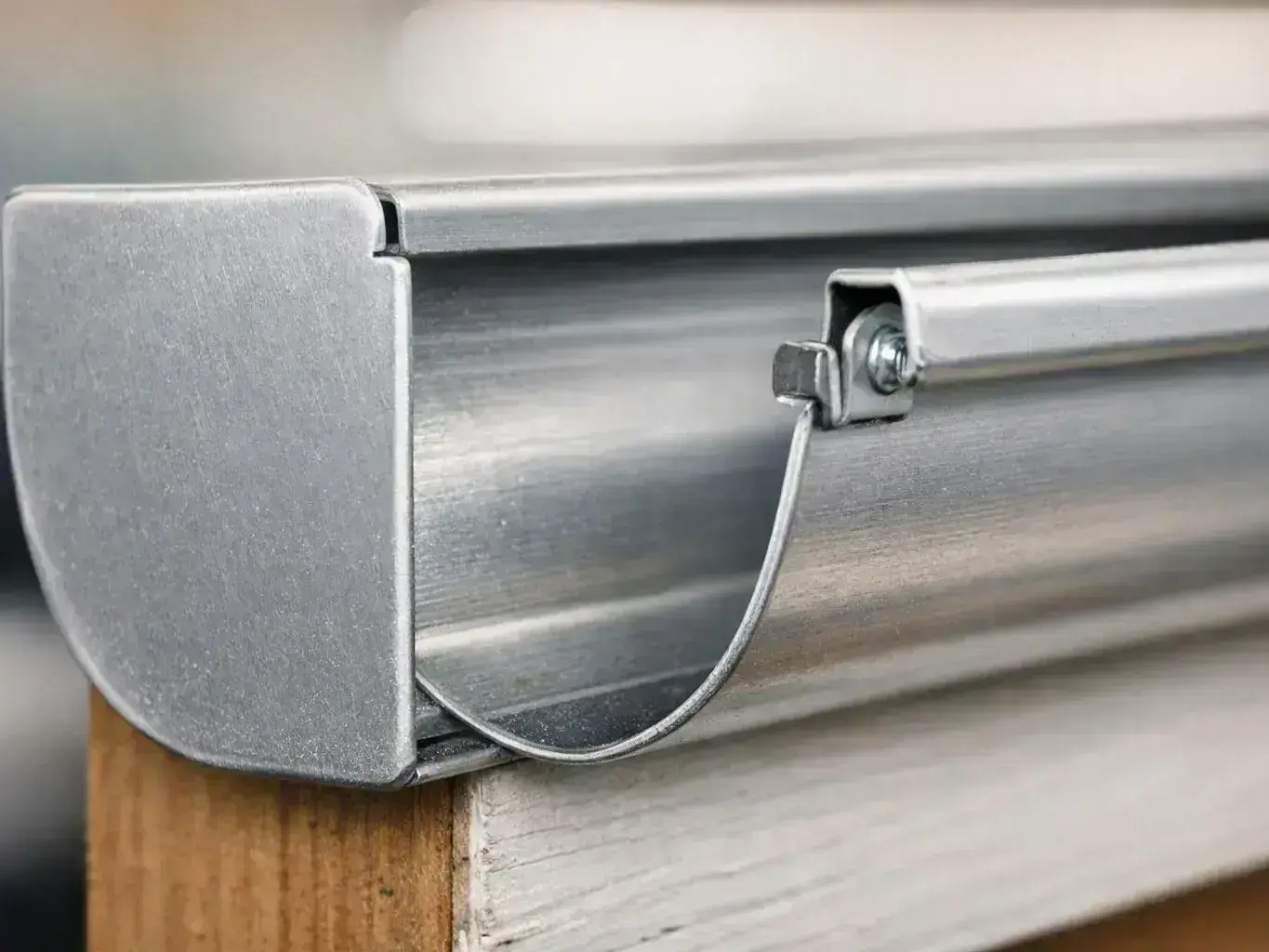 Close-up of a metal blinds headrail mounted on a wooden window frame